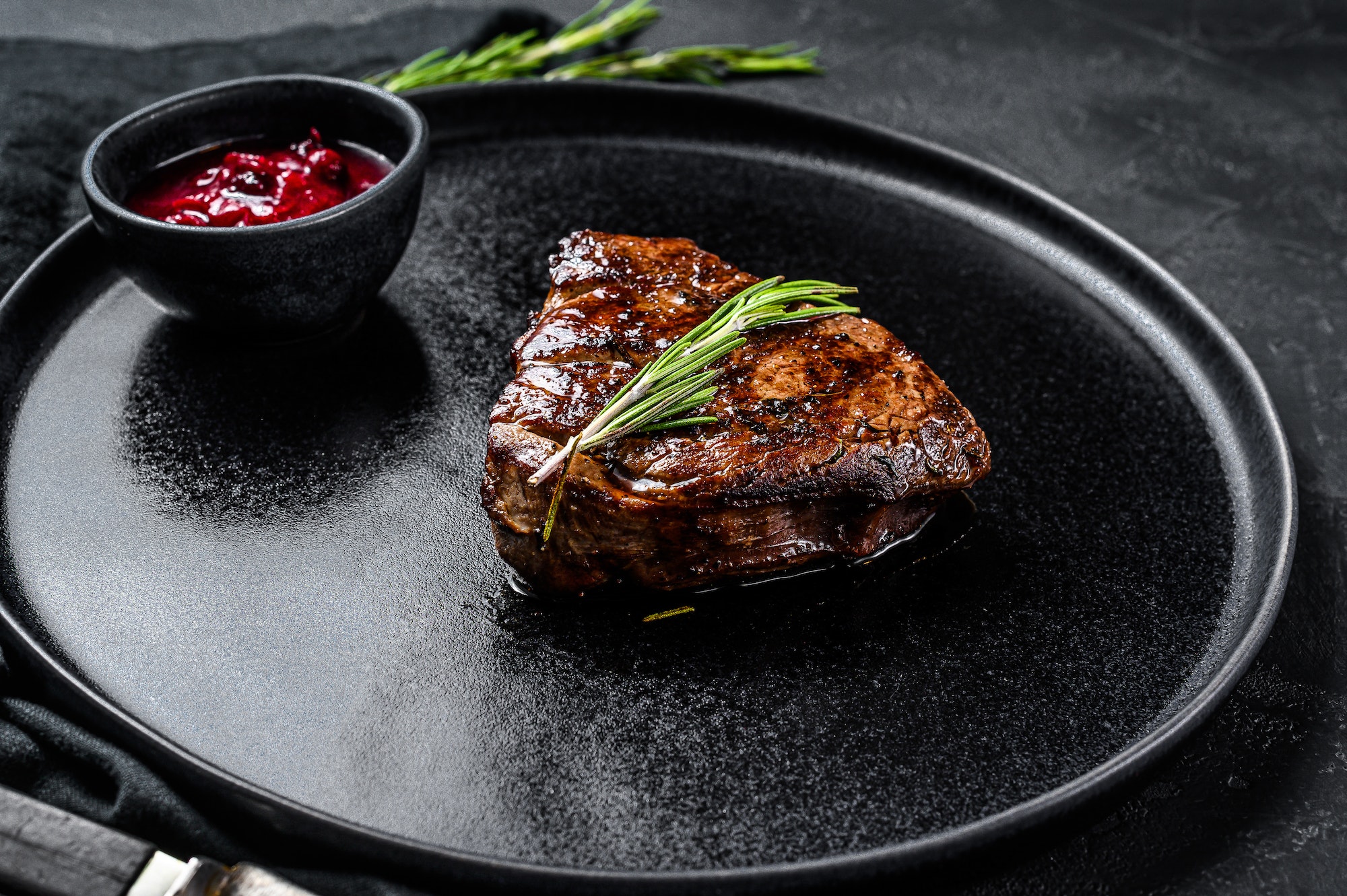 Grilled filet Mignon steak. Beef tenderloin. Black background. Top view